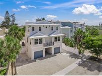 Beautiful two-story home with light exterior paint, a balcony, and two car garage at 340 Avenida De Mayo, Sarasota, FL 34242