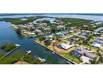 Waterfront home featuring direct boating access to the Gulf of Mexico, with lush tropical landscaping, and circular drive at 4361 Pompano Ln, Palmetto, FL 34221