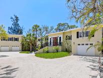 Charming home with meticulous landscaping, impact windows, and large driveway at 7320 Melaleuca Way, Siesta Key, FL 34242