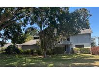Charming two-story home with landscaped yard and mature trees in a quiet residential neighborhood at 1212 Candlewood Dr, Lakeland, FL 33813