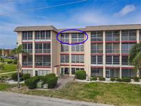 Beautful multifamily building with screened balconies and manicured landscaping at 4189 Heron Way # 406E, Bradenton, FL 34205
