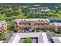 An aerial view shows the condo with beautiful landscaping and golf course views at 4550 Pinebrook Cir # 608, Bradenton, FL 34209