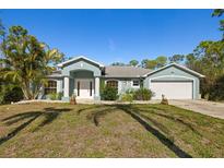 Charming single-story home with well-maintained landscaping, a two-car garage, and attractive curb appeal at 1399 Shields St, Punta Gorda, FL 33980