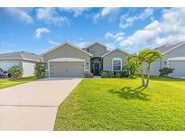 Charming single-story home featuring a well-manicured lawn and a welcoming entrance at 16411 62Nd E Gln, Parrish, FL 34219