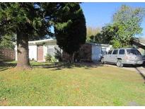 Modest single story home with lawn, mature trees and landscaping at 1909 6Th W Ave, Palmetto, FL 34221