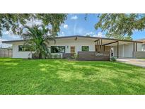 Charming single-story home with a well-manicured lawn and mature landscaping, offering inviting curb appeal at 2516 Goldenrod St, Sarasota, FL 34239