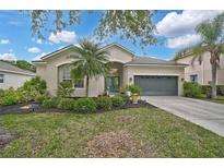 Charming single-story home featuring a well-manicured lawn, lush landscaping, and a two-car garage at 4103 61St E Ave, Bradenton, FL 34203