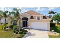 Charming single Gathering home boasts a lush landscaped yard and attached two car garage at 4274 Tennyson Way, Venice, FL 34293