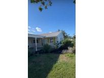 Cozy single-story home with a metal roof, white siding, yellow shutters, and a covered carport at 4408 Mount Vernon Dr, Bradenton, FL 34210
