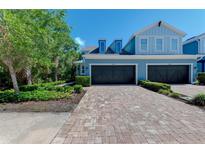 Charming two-story townhome with brick paver driveway and attached two-car garage at 4500 Chinkapin Dr, Sarasota, FL 34232