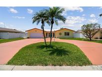 Charming single-story home with two palm trees and a circular driveway at 4829 Commonwealth Rd, Palmetto, FL 34221