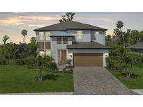 Charming two-story home featuring a two-car garage, landscaped yard, and a welcoming entrance at 5651 Trevesta Pl, Palmetto, FL 34221