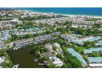 Breathtaking aerial view showcasing waterfront homes with boat docks and stunning beachside proximity at 5681 Midnight Pass Rd # 104, Sarasota, FL 34242