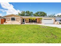 Charming single-story home with a well-manicured lawn and inviting curb appeal on a sunny day at 6760 14Th S St, St Petersburg, FL 33705