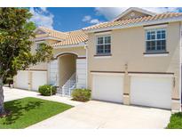 Charming townhome exterior with attached garages and manicured landscaping under a sunny sky at 7035 Scrub Jay Way # 202, Bradenton, FL 34203