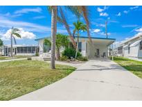 Charming single-story home with well-maintained lawn and tropical landscaping, perfect for relaxing in a sunny location at 714 N Waterway Dr, Venice, FL 34285