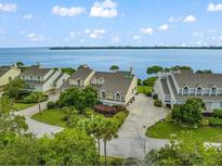 Stunning waterfront homes with lush landscaping and inviting curb appeal in a desirable community at 76 Tidy Island Blvd, Bradenton, FL 34210