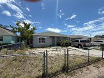 Modest single-story home with a chain-link fenced yard, offering curb appeal and security at 815 12Th W Ave, Bradenton, FL 34205