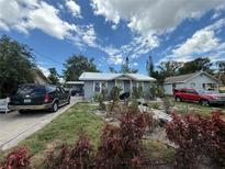 Charming single-story home with a metal roof, complemented by a landscaped front yard at 1113 23Rd W Ave, Bradenton, FL 34205