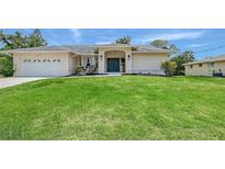 Charming single-story home featuring a well-manicured lawn and tasteful landscaping, plus an attached two-car garage at 1626 Ridgewood Ln, Sarasota, FL 34231