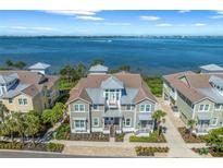 Beautiful two-story waterfront home featuring lush landscaping and a welcoming front porch at 276 Saint Lucia Dr # 101, Bradenton, FL 34209