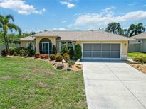 Charming single-story home with a well-manicured lawn and screened two-car garage at 2801 Dalhart Ave, North Port, FL 34286