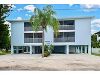 Coastal home featuring two stories, stilt construction, a well-manicured lawn and multiple screened-in balconies at 3703 5Th Ave # 3, Holmes Beach, FL 34217
