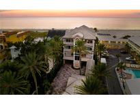 Stunning beachfront home featuring a multi-story design with palm trees and ocean views at 3800 Gulf Blvd # Ph, St Petersburg, FL 33706