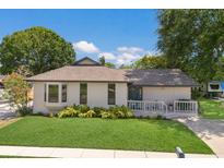 Charming single-story home with well-manicured lawn, a cozy front porch, and beautiful landscaping at 5403 2Nd W Ave, Bradenton, FL 34209