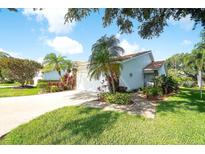 Charming single-story home with a well-manicured lawn, vibrant landscaping, and a two-car garage at 5812 Garden Lakes Fern, Bradenton, FL 34203