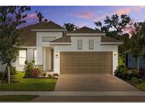 Charming home featuring a two-car garage, brick paver driveway, and manicured landscaping at 5816 Mezzana Run, Palmetto, FL 34221