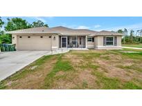 Charming single-story home with a two-car garage and screened front porch at 6104 Plamendon Ave, North Port, FL 34291