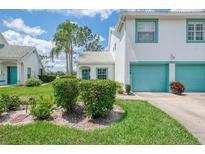 Charming two-story home with a two car garage, lush lawn and teal trim accents at 6546 Fairway Gardens Dr # 6546, Bradenton, FL 34203