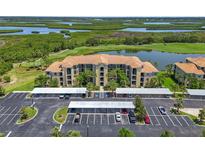 Beautiful condo with well-kept covered parking, landscaping and a view of the lake and surrounding nature preserve at 7005 River Hammock Dr # 203, Bradenton, FL 34212