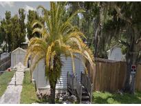 A small white house with a palm tree in the front yard and a wooden fence on the side at 710 25Th W Ave, Bradenton, FL 34205