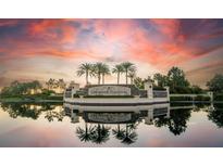 Beautiful entrance to Lakewood National with palm trees and sunset sky at 16904 Vardon Ter # 208, Lakewood Ranch, FL 34211