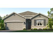 Charming single-story home with stone accents, a two-car garage, and a well-manicured lawn at 18212 Wheathouse Pl, Lakewood Ranch, FL 34211
