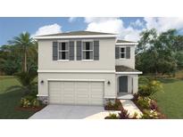 Charming two-story home with a two-car garage, stylish shutters, and a well-manicured lawn at 3210 Bitterroot Ln, Lakewood Ranch, FL 34211