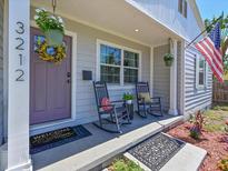Charming front porch with rocking chairs, welcome mat, and decorative plants creates a warm, inviting entrance at 3212 Avenue A W, Bradenton, FL 34205
