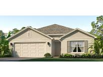 Charming single-story home features a two-car garage, neutral siding, and well-manicured landscaping at 4415 Dusky Dawn Ln, Palmetto, FL 34221