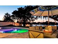 Inviting outdoor space with a pool and fire pit at sunset at 4708 26Th W Ave, Bradenton, FL 34209