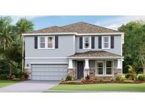 Charming two-story home featuring stone accents, a covered porch, a two-car garage, and manicured landscaping at 5112 Rosado Run, Bradenton, FL 34211