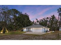 Charming one-story home featuring an attached garage, well-maintained landscaping, and a spacious front yard at 6766 Beedla St, North Port, FL 34291