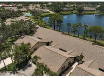 A beautiful aerial view of the homes, a lake, and a community pool surrounded by mature trees and lush landscaping at 7118 Lakeside Dr # 7118, Sarasota, FL 34243