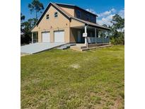 Inviting two-story home with a spacious two-car garage and charming front porch at 8412 Grove Blvd, Punta Gorda, FL 33982