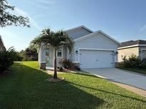 Charming single-story home with a well-manicured lawn, paver accents, and a two-car garage, providing comfort and curb appeal at 10962 High Noon Trl, Parrish, FL 34219