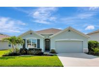 Charming single-story home featuring a well-manicured lawn and attached two-car garage at 12712 Dusty Trail Dr, Sarasota, FL 34238