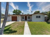 Charming single-story home featuring a well-maintained lawn and welcoming front porch, perfect for relaxed living at 138 Pearl Ave, Sarasota, FL 34243