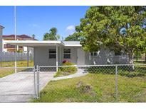 Charming single-story home featuring a covered parking area and fenced yard, offering both convenience and security at 2739 Palmadelia Ave, Sarasota, FL 34234