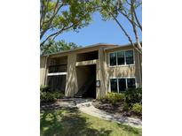 Inviting condo building with landscaped grounds, offering serene residential living and easy access at 4037 Crockers Lake Blvd # 14, Sarasota, FL 34238